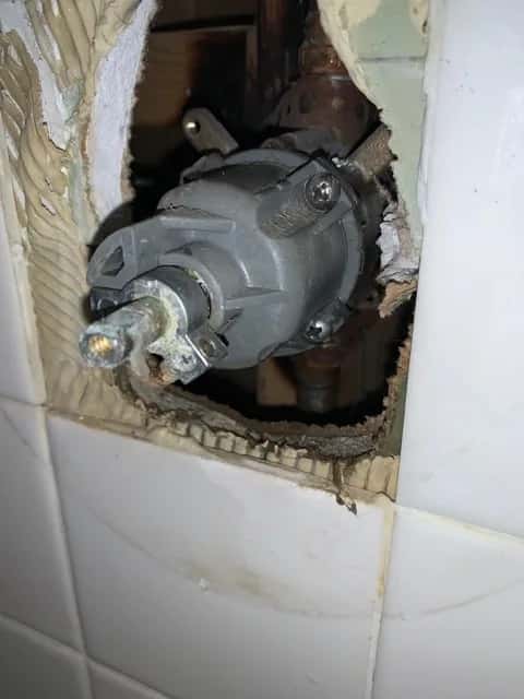 Valve work inside an opened wall.