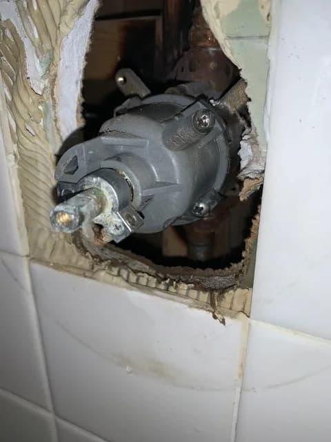 Valve work inside an opened wall.