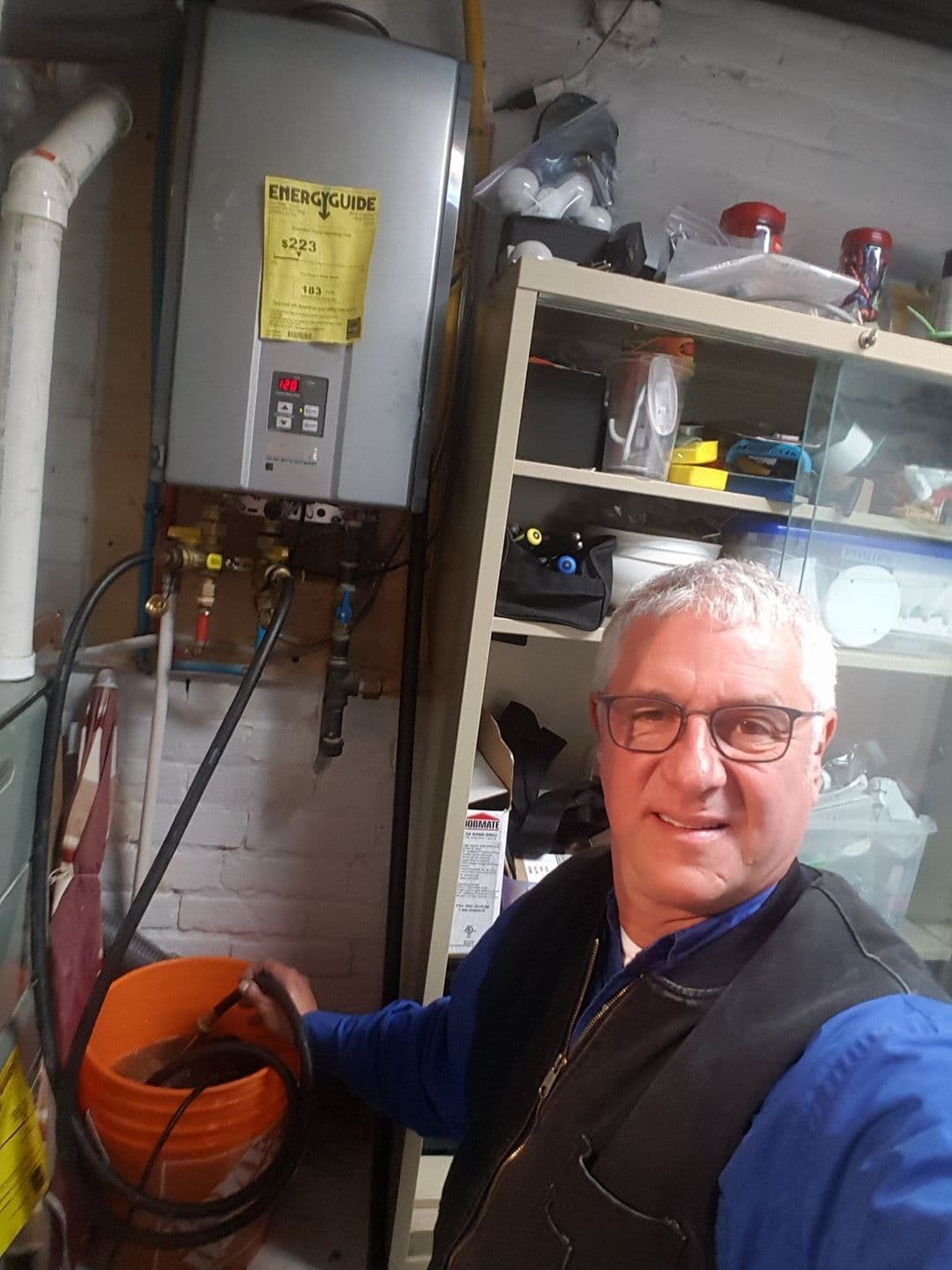 Wall-mounted tankless water heater in a basement utility area